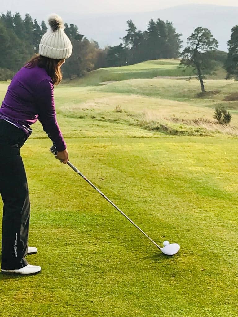 woen playing golf in winter wear